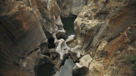 Rock-formations-from-flowing-water-at-a-quarry-in-South-Africa---4k