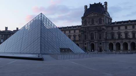 4K-Louvre-pyramid-and-museum-slow-truck-left-wide-shot-during-early-morning-with-nobody