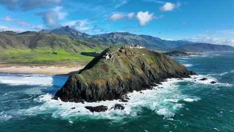 Aerial-shot-of-Point-Sur-Lighthouse-along-Big-Sur-Highway-1,-Waves-crashing-below-Ocean-Coastline,-California