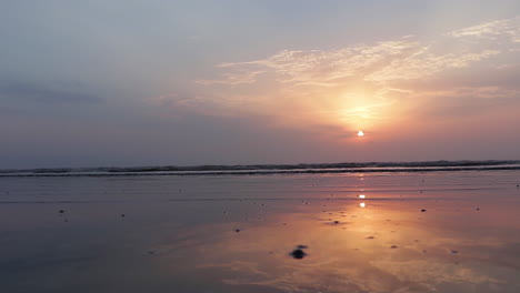 Crystal-clear-reflection-of-sunset-sky-on-wet-sand-at-beach-in-4k,-beautiful-sunset-at-seashore,-amazing-horizon,-Indian-beach,-nature