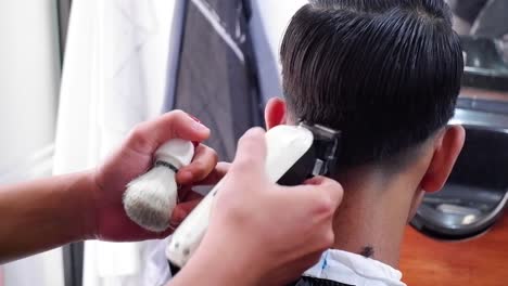 closeup-hair-cut-in-barber-shop-dark-lighting