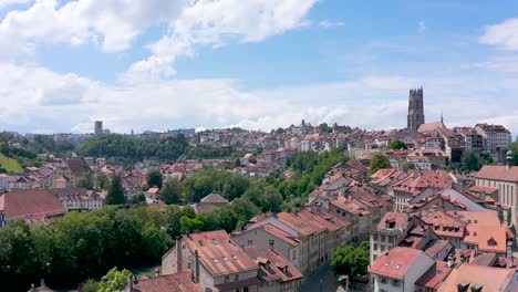 Beautiful-sunny-day-in-cultural-rich-Fribourg,-idyllic-city-in-Switzerland,-rising-aerial