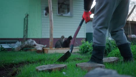 Crop-Image-Of-A-Person-With-Shovel-Gardening-At-Backyard-Lawn-During-Sunset