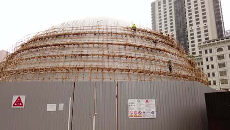 Traditional-Bamboo-Scaffolding-covering-an-oval-structure-in-Downtown-Hong-Kong