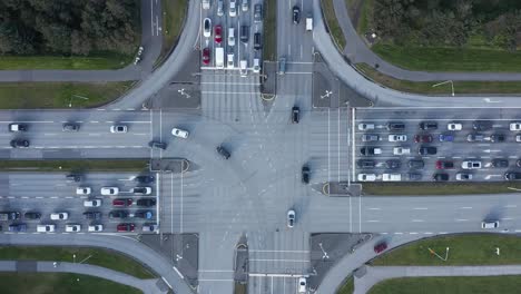 Big-intersection-cross-roads-in-capital-Reykjavik,-busy-traffic-rush-hour,-drone-shot