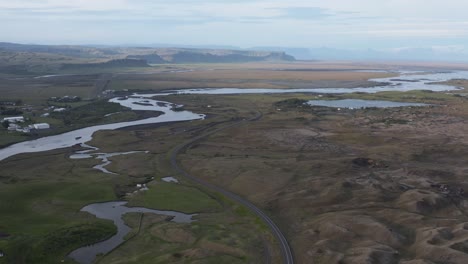 Hringvegur-ring-road-passing-through-Kirkjubæjarklaustur-remote-town-in-Iceland,-aerial
