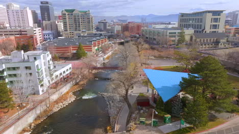 Aerial-trucking-to-the-right-over-the-Truckee-River-in-downtown-Reno,-Nevada