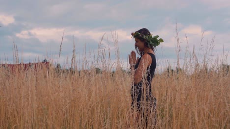 Gorgeous-Woman-Praying-In-The-Midst-Of-Golden-Crops-In-Olomouc,-Czech-Republic-On-A-Sunset---tracking-shot---slow-motion