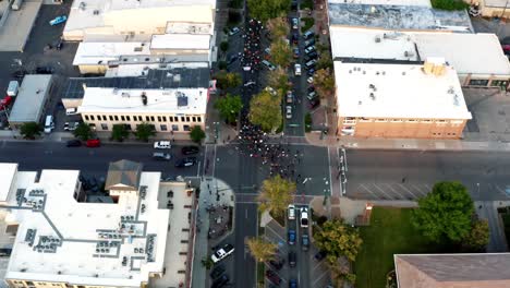 Provo,-Utah---USA---July-1st-2020:-Aerial-top-bird's-eye-drone-shot-of-Pro-Trump-protestors-walking-in-the-middle-of-center-street-after-a-shooting-at-a-Black-Lives-Matter-Protest-the-day-before