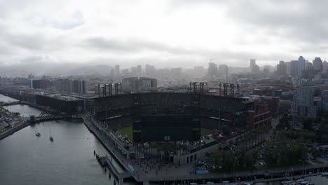 Aerial-reverse-pullback-shot-of-Oracle-Park-with-Downtown-San-Francisco-in-the-background-on-a-foggy-day