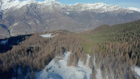 drone-flying-above-the-mountains-during-winter,-forward-movement
