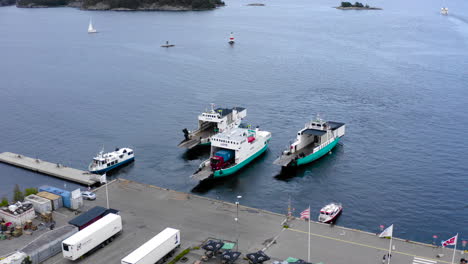 Aerial-view-three-cargo-shipment-shipping-vessels-boats-leave-city-port-transportation-manufactured-goods-global-shipping-sea-peninsula-island-maritime-sister-ship-oil-tanker-mission-start-journey