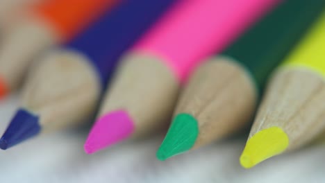 Extreme-Close-Up-Of-Orange,-Blue,-Pink,-Green,-And-Yellow-Colored-Pencils,-Isolated-On-White