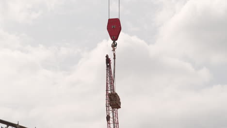 Tower-Crane-Hook-Block-And-Hook-Lifting-Materials-At-Construction-Site