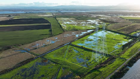 Aerial-view-of-Sherman-Island-Marshy-fields-and-Electric-power-lines-on-Wild-Life-Area,-California