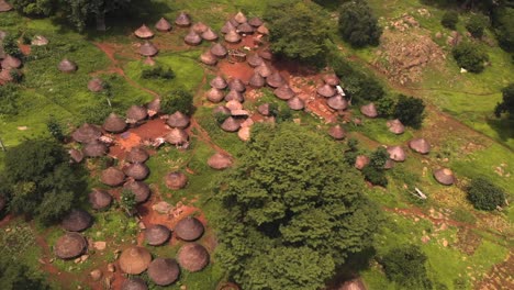Aerial-view-of-small-rustic-houses-in-local-village,-Senegal,-Africa,-forest,-drone-shot