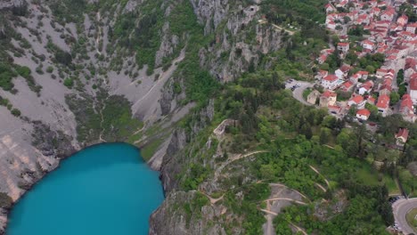 Aerial-view-of-Imotski,-Croatia-on-edge-of-cliff-overlooking-Blue-Lake