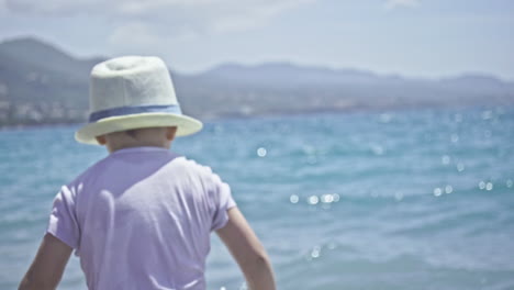 Three-Years-Old-Kid-Enjoys-The-Sea-And-The-Waves-At-Kalamata-Beach,-Greece-SLOW-MOTION