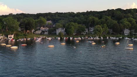 Beautiful-cottage-country-aerial-view-of-boats-anchored-and-docked-on-the-cottage-lake-front-shore-line-at-lake-Geneva,-Wisconsin