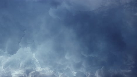 POV-lightning-flashes-among-dark-and-moving-cumulonimbus-clouds,-thunderstorm-4K