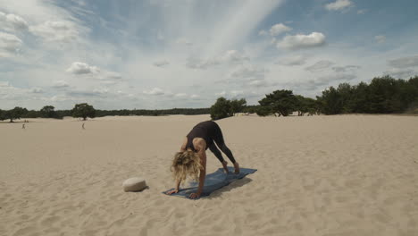 Woman-changing-pose-from-upward-facing-dog-to-downward-dog---yoga-exercise