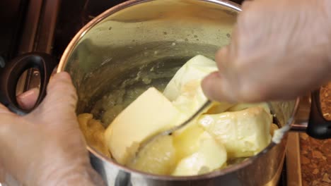 Breaking-up-butter-being-heated-in-a-saucepan-for-a-boiled-icing-recipe