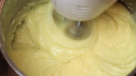 Using-an-electric-double-whisk-to-mix-cake-batter-in-a-metal-bowl
