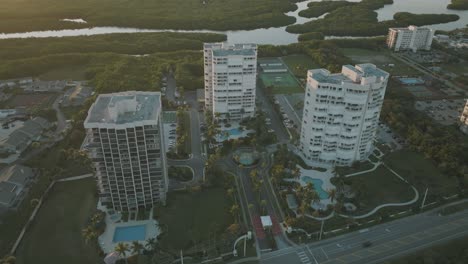 Aerial-video-of-high-rise-condominiums-on-the-Florida-coast-during-sunset