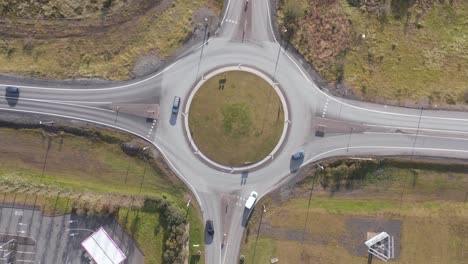 Top-down-of-a-peaceful-roundabout-with-traffic-on-sunny-day