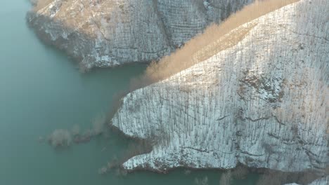 Aerial-view-of-a-lake-surrounded-by-the-snow