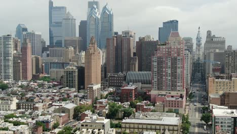 Tight-aerial-tilt-up-reveals-Philadelphia-skyline-skyscrapers,-downtown-financial-district,-City-Hall,-S-Broad-St,-City-Hall,-summer-day,-establishing-shot-urban-city-in-USA