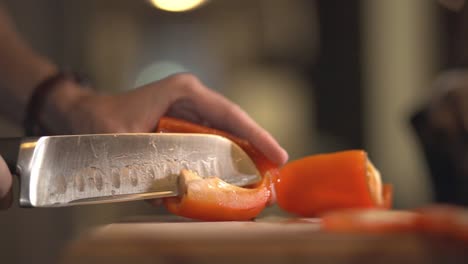 Removing-The-Seeds-Of-A-Red-Capsicum-Using-A-Sharp-Knife-Over-The-Wooden-Board