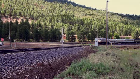 A-passenger-train-approaches-a-railway-crossing-triggering-the-guard-gates-to-drop