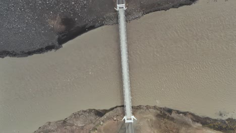 Top-down-aerial-of-remote-Jokulsa-bridge-in-North-Iceland,-brown-glacial-river