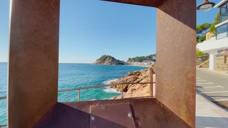 View-through-a-metal-frame-passing-through-the-bay-of-Tossa-de-Mar-in-the-background