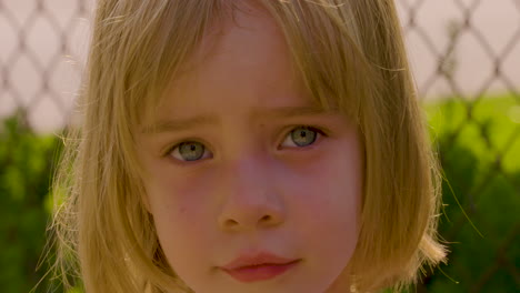 Outdoor-portrait-of-an-adorable-blue-eyed-little-girl