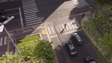 Aerial-view-of-juggler-performing-at-zebra-crossing-during-red-traffic-light