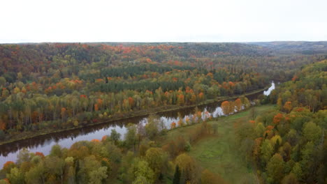 Autumn-Landscape-View-of-the-Gauja-River-by-Forests-Colorful-Bright-Yellow-Orange-and-Green-Trees,-Sunny-Day