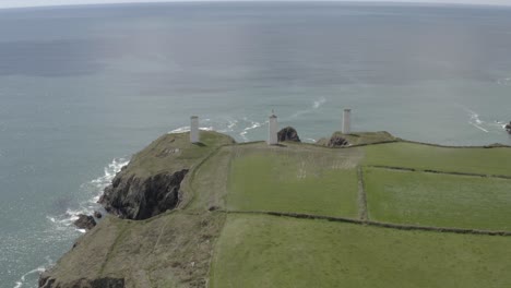 Aerial:-Metal-Man-tower-beacons-on-high-coastal-cliff-protect-mariners