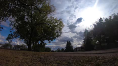 TIMELAPSE---Clouds-traveling-in-front-of-the-sun-with-a-view-of-an-empty-street-in-a-small-town-near-Alberta-Canada-on-a-nice-day