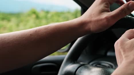 Detail-close-up-of-a-mans-hands-driving-the-car-in-slow-motion