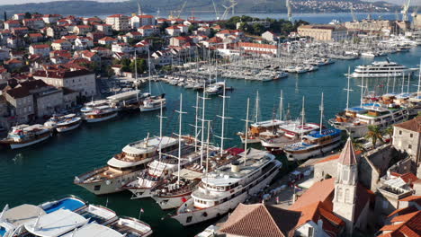 Cruise-Boats-Docking-In-Harbor-Of-Trogir-Town-During-Summer-In-Croatia---aerial-drone-shot