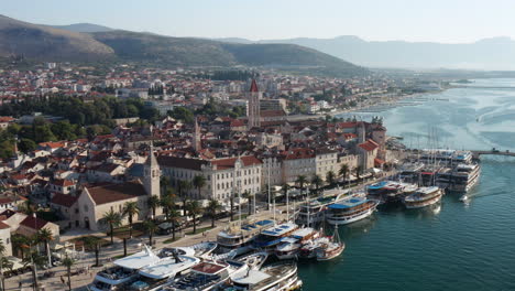 Aerial-View-Of-The-Old-Town-Of-Trogir-With-Ferry-Boats-Dock-At-The-Port-In-Adriatic-Sea,-Dalmatia,-Croatia