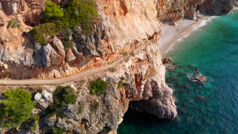 Aerial:-amazing-coastal-walkway-path-along-Croatian-cliffs-on-Adriatic-Sea-with-turquoise-water