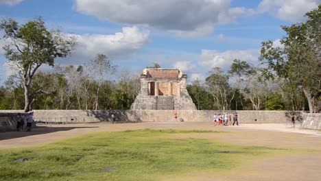 Tourists-visiting-Temple-of-the-Bearded-Man-or-the-North-Temple-in-the-Great-ball-court,-Chichen-Itza-archaeological-site