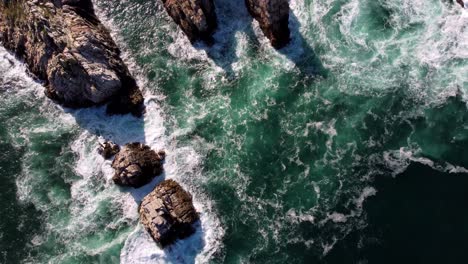 Birds-Eye-Top-Down-View-of-Natural-ocean-waves-and-rock-cliff-formation,-Mother-Earth-environmental-concept