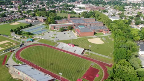 High-aerial-of-school-college-university-campus-athletic-fields,-grounds-and-school-buildings-in-Lancaster-Pennsylvania-USA