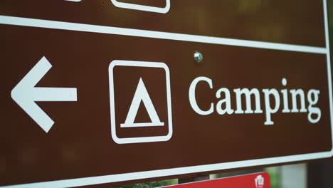 Close-up-view-of-black-color-Camping-Road-Sign-indicating-the-the-direction-of-the-camp-site