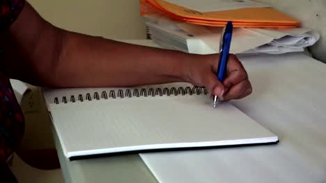 Black-woman-taking-notes-in-a-notebook