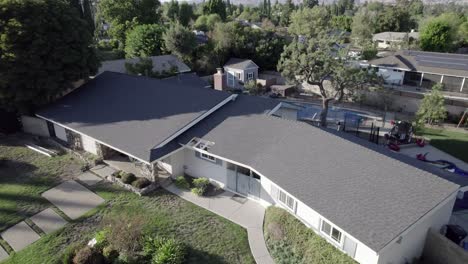 Aerial-descending-view-above-contemporary-Northridge-residential-property-San-Fernando-Valley-Neighbourhood